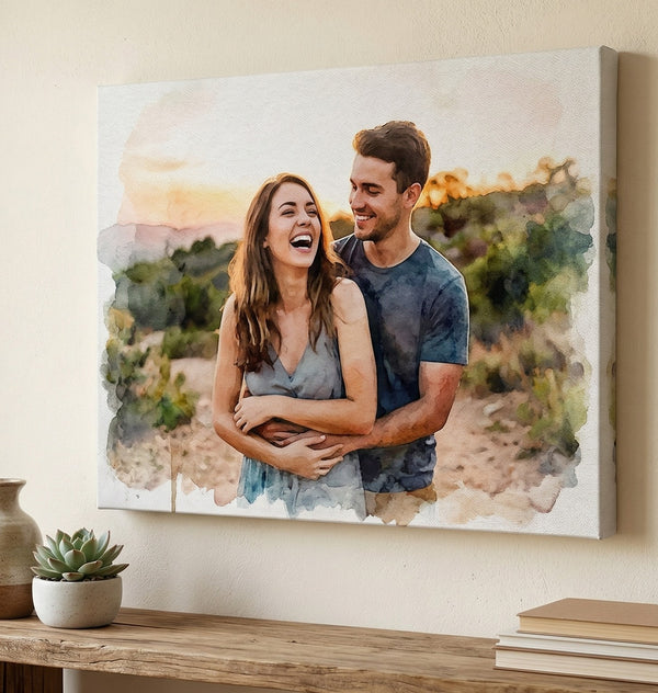 Canvas print of a couple embracing with a watercolor effect, hanging on a wall above a wooden table.